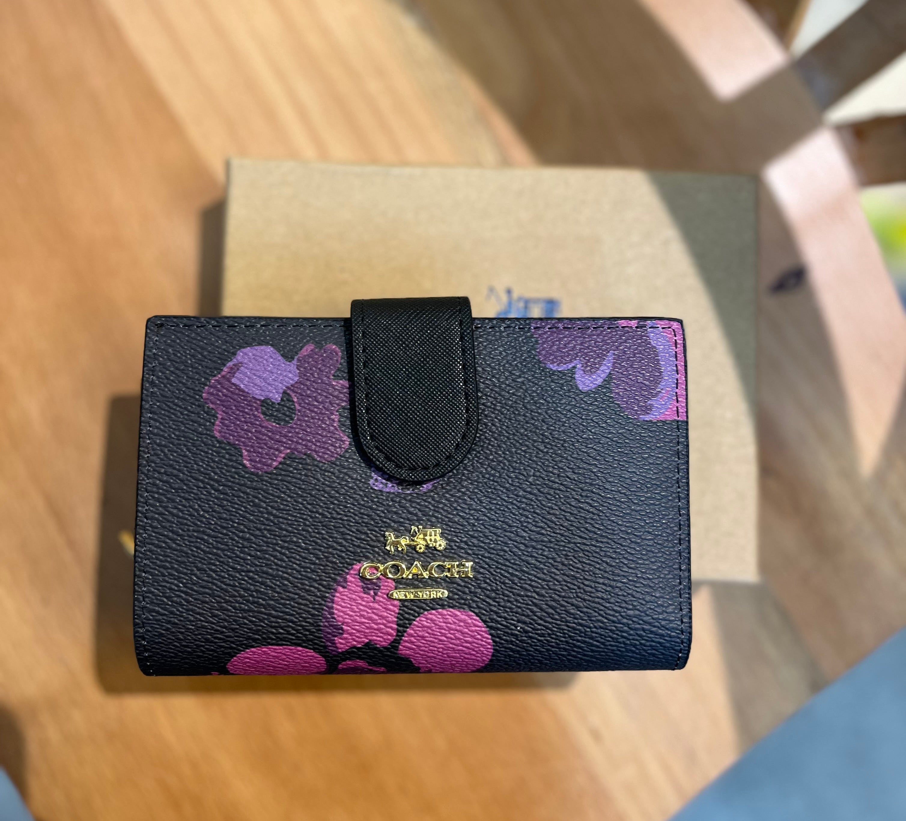 Coach women’s pouch ( black multi floral )