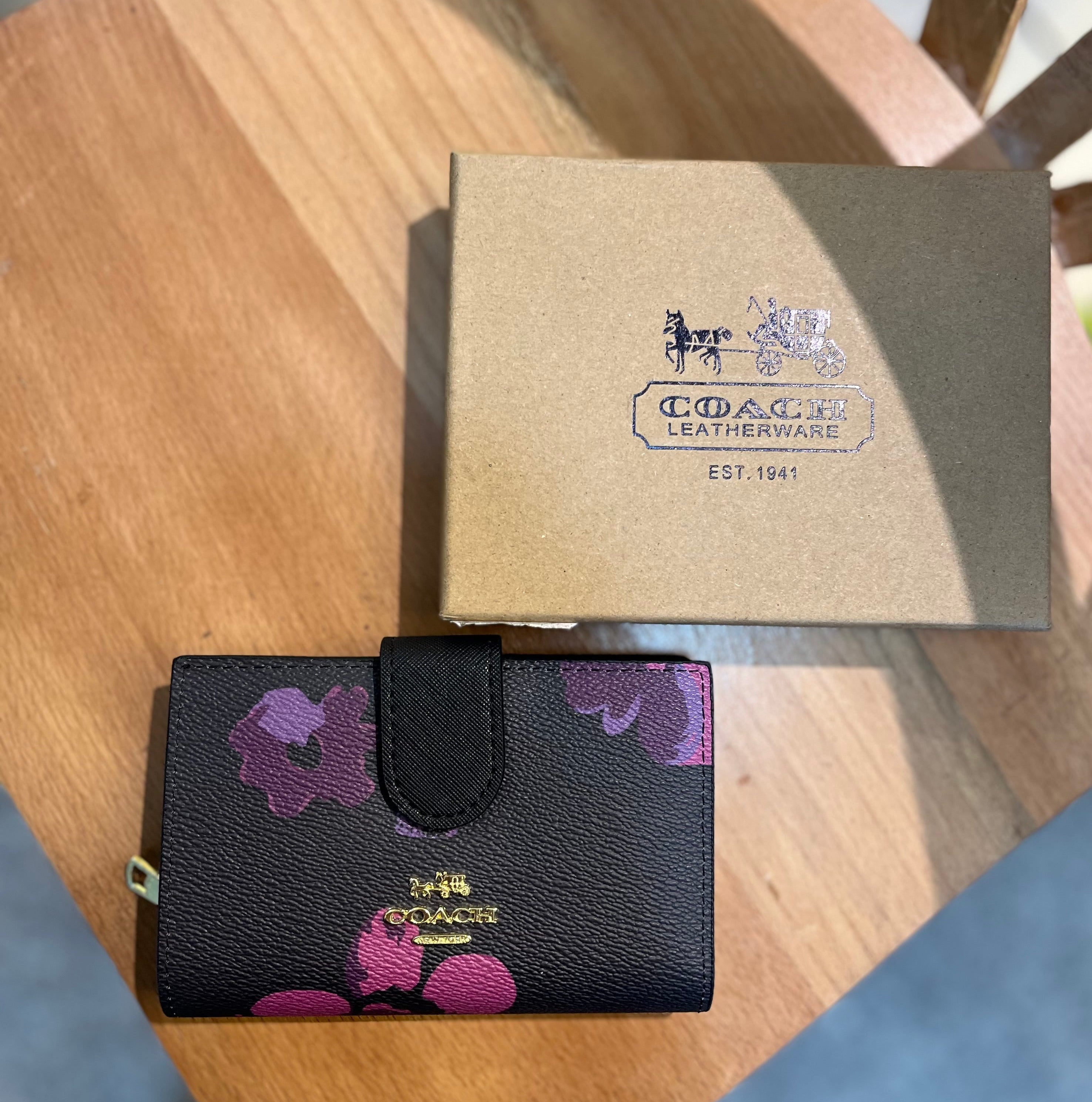 Coach women’s pouch ( black multi floral )